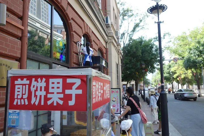 A jianbing guozi cart on a city sidewalk